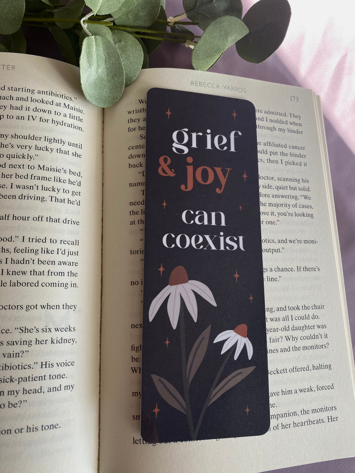 Grief & Joy can coexist bookmark displayed on a book