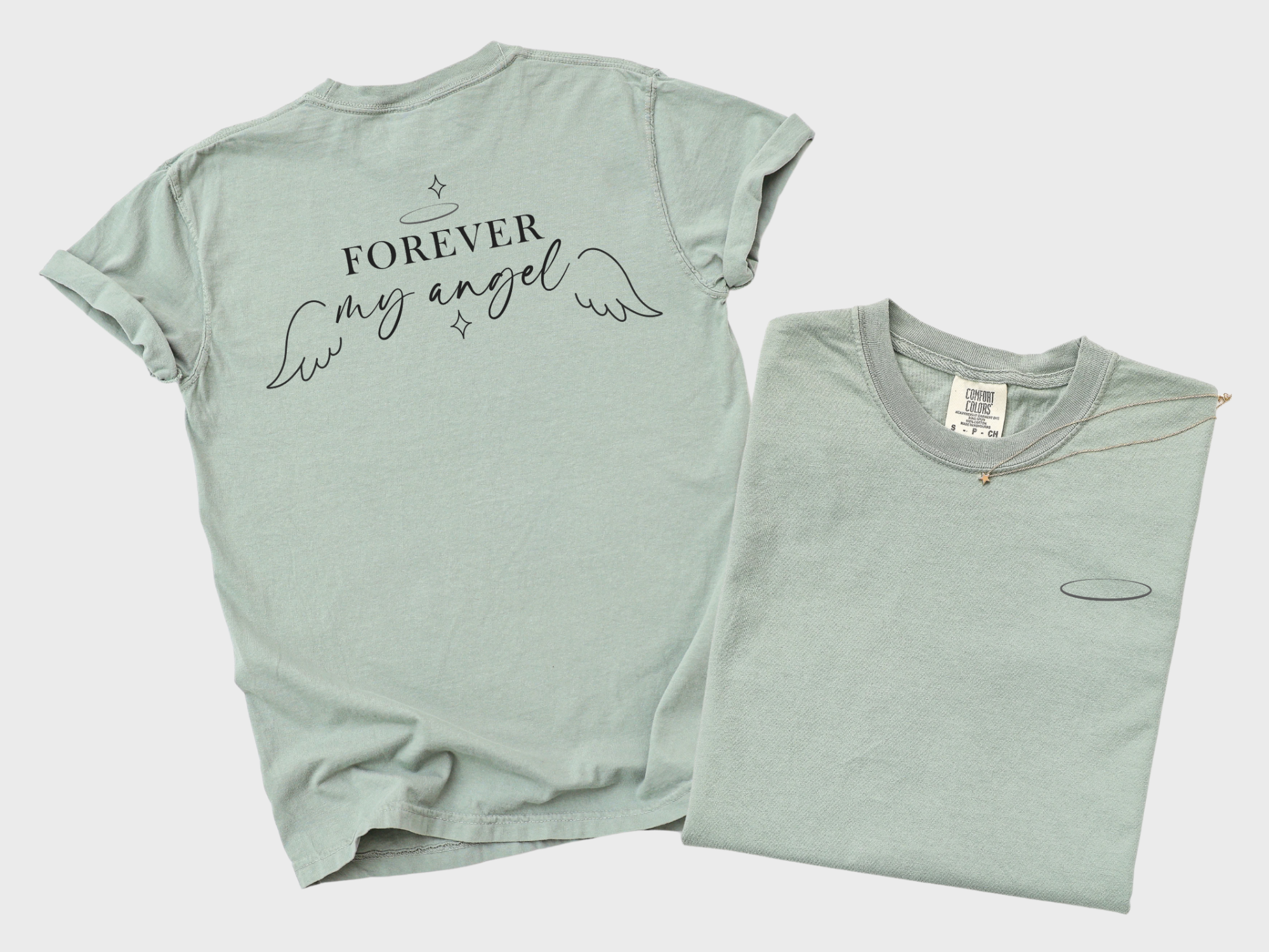 White background with a bay colored shirt. The back of the shirt showcasing the words "Forever my Angel" with wings and a halo. The front of the shirt with a halo on the left chest pocket area.